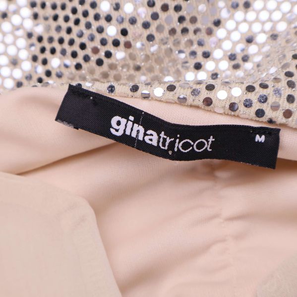 Svart Gina Tricot-etikett med storlek M i toppen