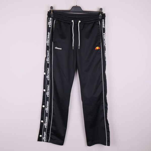 Svarta träningsbyxor med vita tryckknappar och logoband vid sidorna