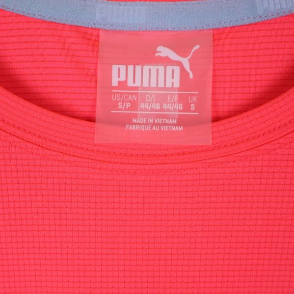 Närbild på t-shirtens etikett med storlekar och Puma-logga