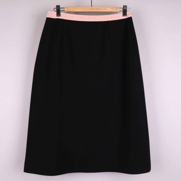 Svart a-linjekjol med rosa midjeband framifrån