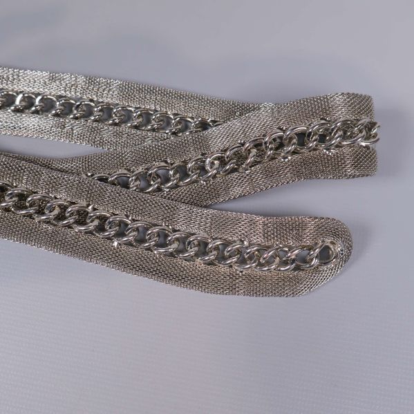 Närbild på kedjedetaljer längs skärpets band