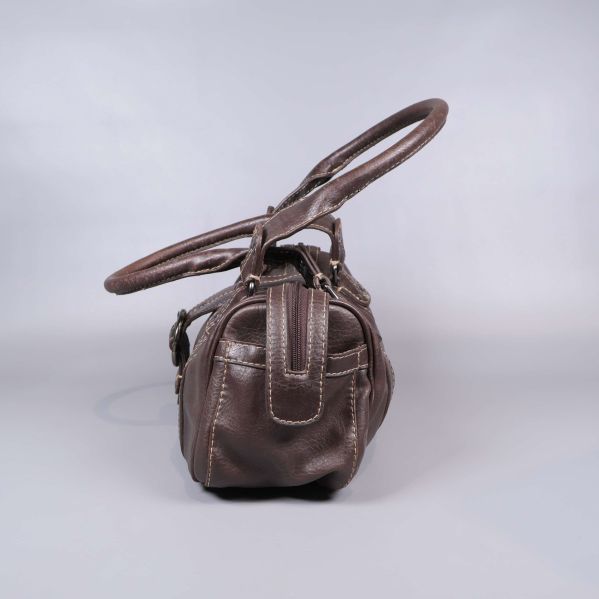 Sidan av brun axelväska med yttre ficka och handtag