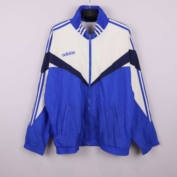Blå och vit Adidas sportjacka med dragkedja hängande framifrån
