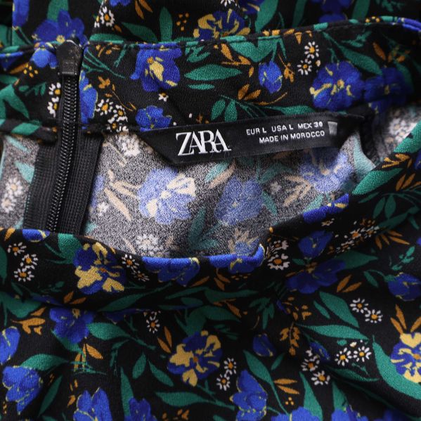 Närbild på ZARA-märkt klänning med dragkedja i sidan