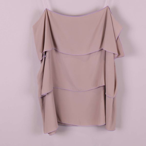 Närbild på volanger och tygstruktur i toppen