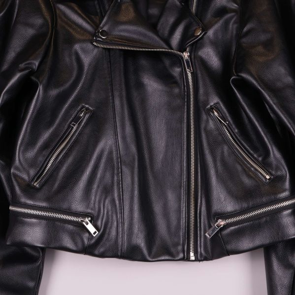 Närbild på dragkedjor och fickor framtill på jackan