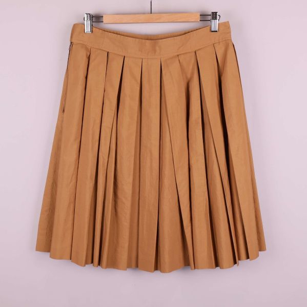 Baksida av beige kjol med tydliga veck