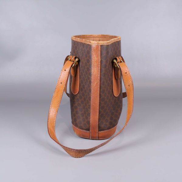 Sida av mönstrad toteväska med bruna läderdetaljer