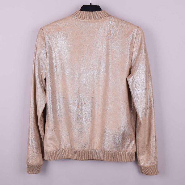 Baksidan av beige glittrig bomberjacka med ribbad nederkant