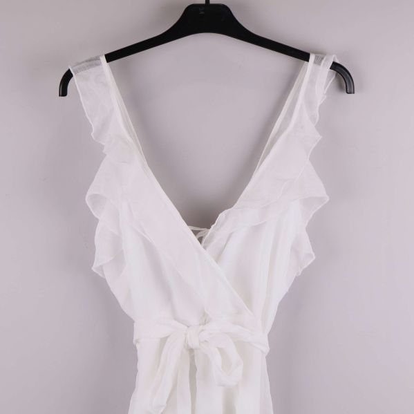 Närbild av klänningens axelband och volanger