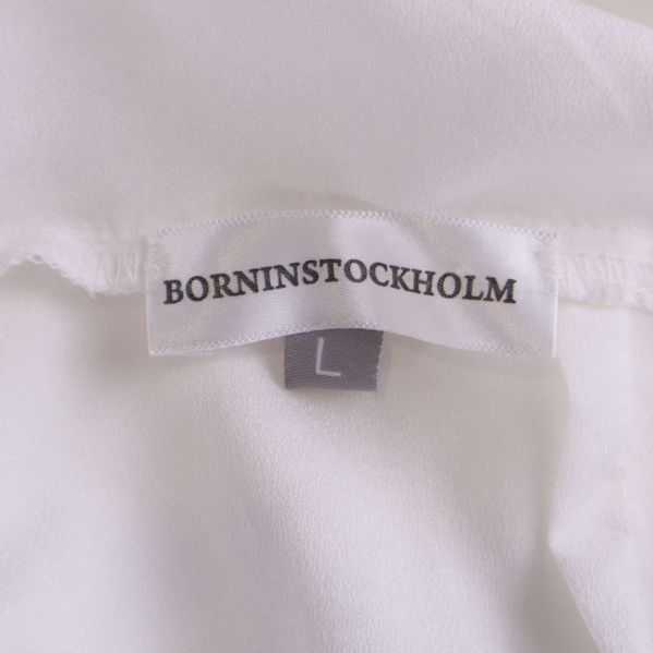 Nacketikett med BORNINSTOCKHOLM och storlek L