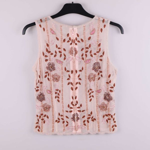 Baksidan av transparent broderad topp med dragkedja