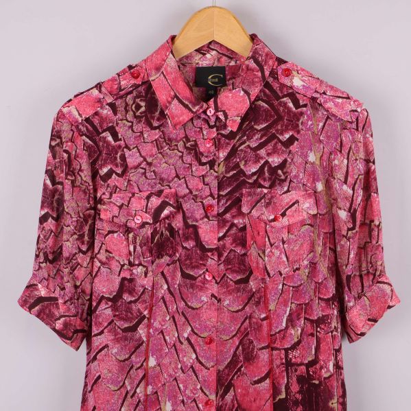 Närbild på ovandelen av blusen med krage, fickor och knappar