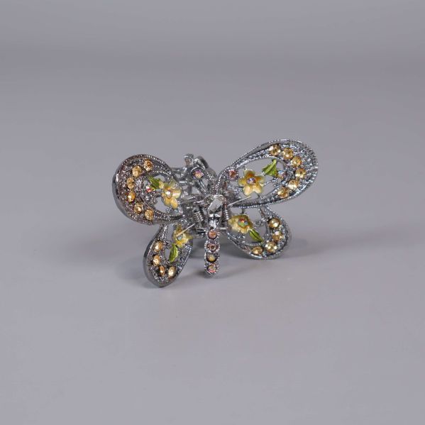 Brosch formad som fjäril med glittrande stenar och blommönster
