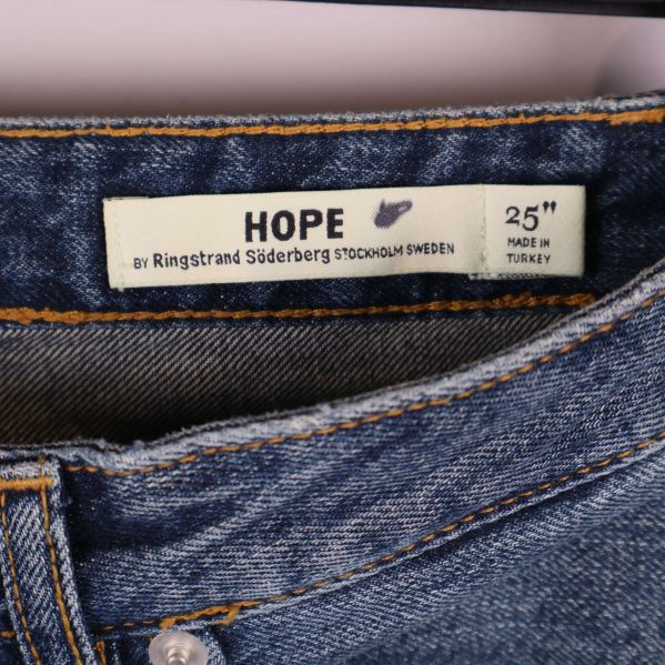 Hope-logotyp och storleksetikett i jeanslinning