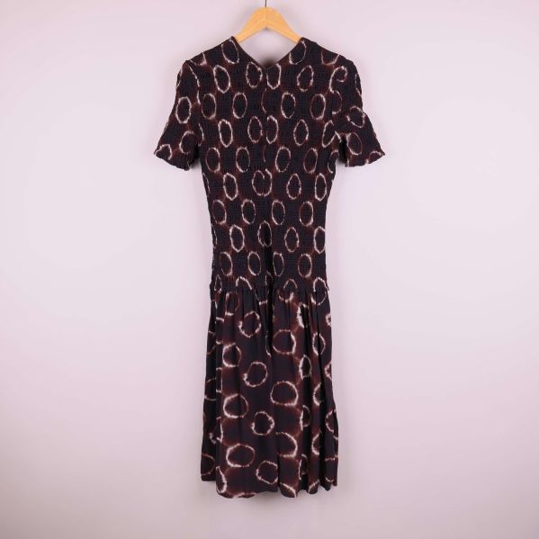 Batikmönstrad klänning fotograferad bakifrån på galge