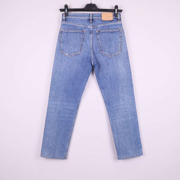 Baksida av raka ljusblå jeans mot vit bakgrund