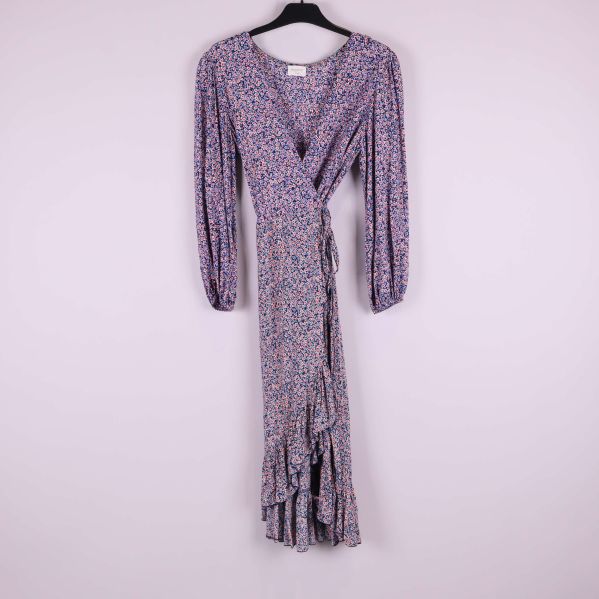 Helbild på långärmad blå klänning med blommigt mönster