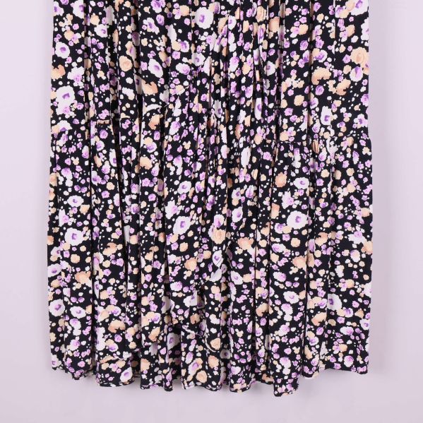 Nederdel av svart blommig plisserad midikjol