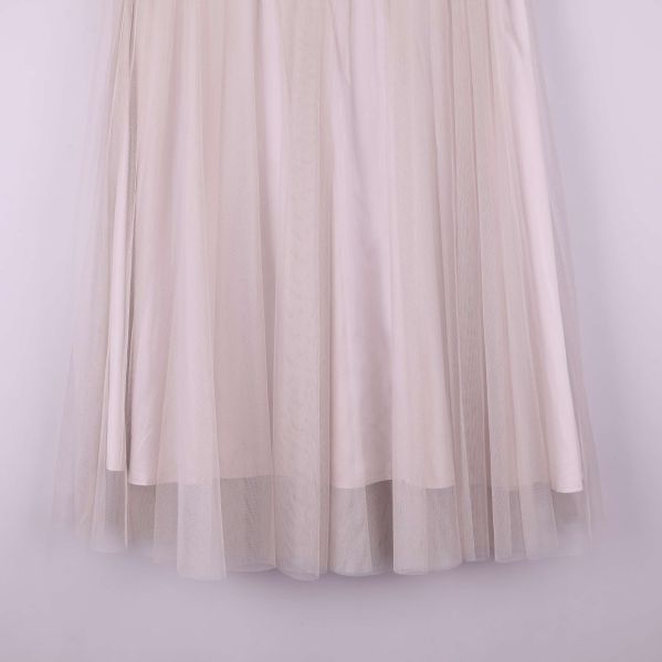 Närbild på nedre delen av kjol med flera lager ljus tyll