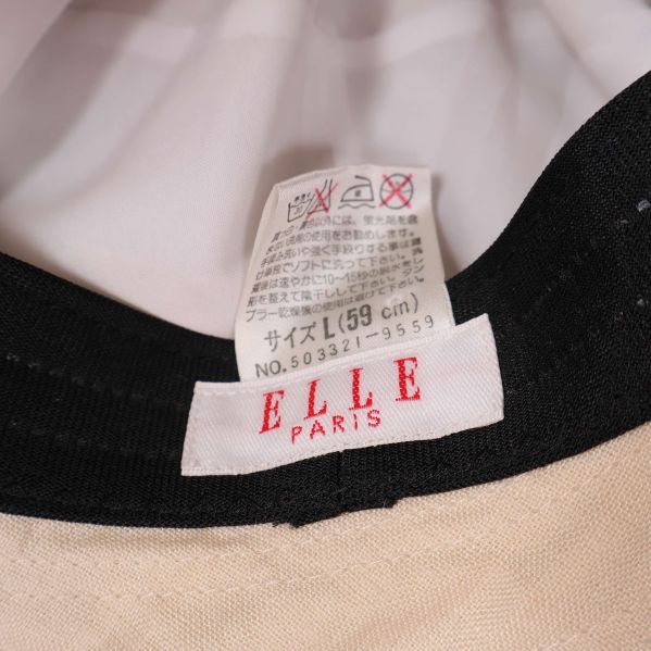Närbild på ELLE Paris etikett och storlekslapp