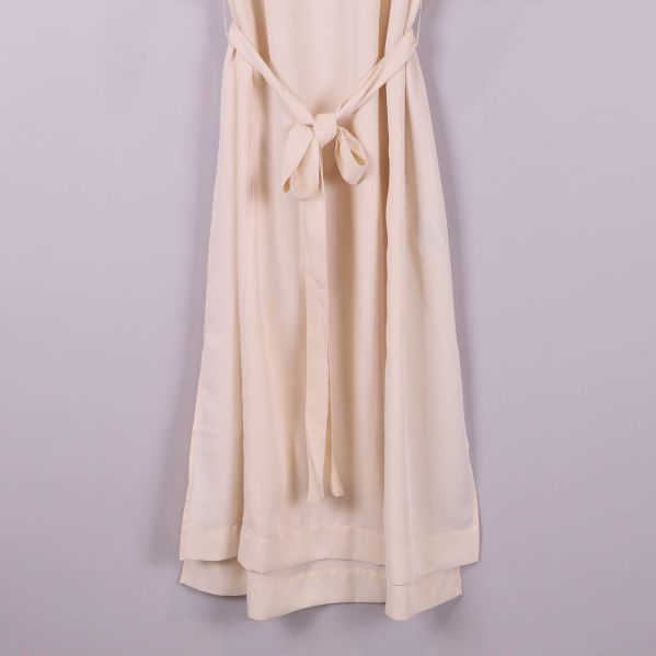 Närbild på klänningens nedre del och skärp