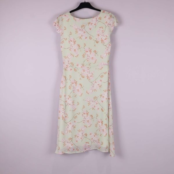 Baksidan av ljus blommig klänning på galge