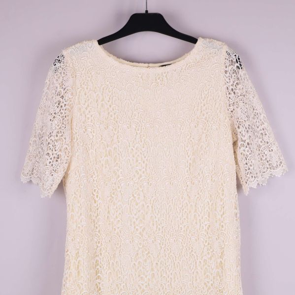 Närbild på klänningens överdel och spetsdetaljer