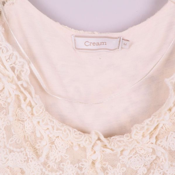 Närbild på etiketten Cream och storlek M i klänningen