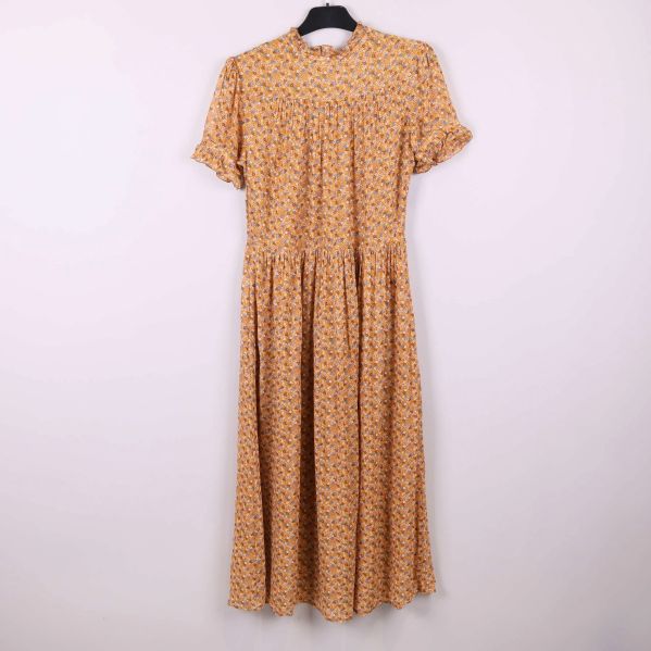 Blommig klänning sedd rakt framifrån på galge