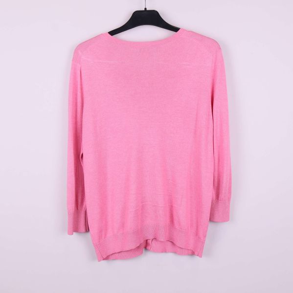 Baksidan av rosa cardigan visas på galge