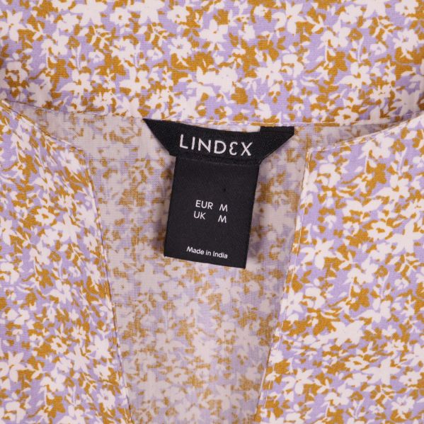Närbild Lindex-märkning i halsen på klänningen