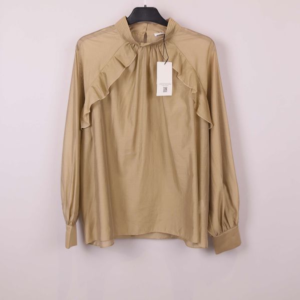 Beige blus med lång ärm och volanger framtill