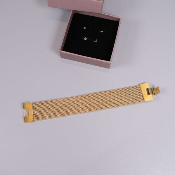 Armband i guld utsträckt med öppet lås