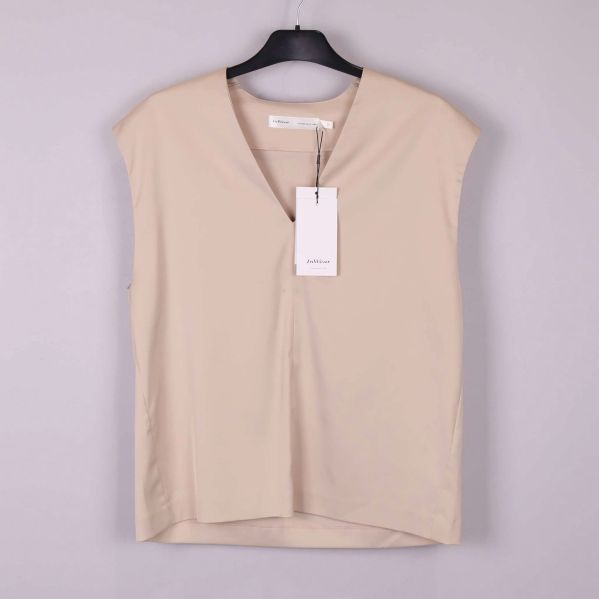 Ärmlös beige topp med v-ringning framifrån