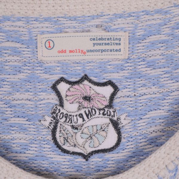 Insida av cardigan visar broderad badge och Odd Molly-etikett