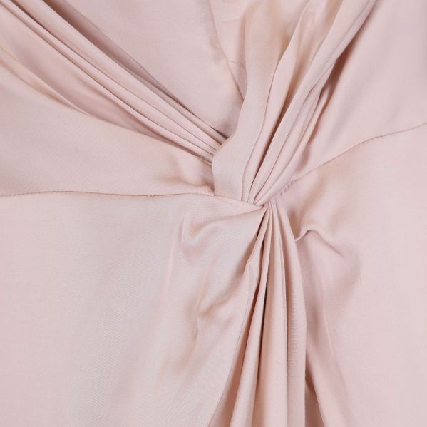 Närbild på draperad detalj på kjolens framsida