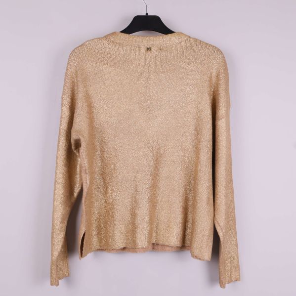 Baksidan av beige glittrig tröja med långa ärmar