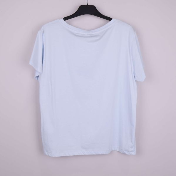 Ljusblå t-shirt bakifrån på galge