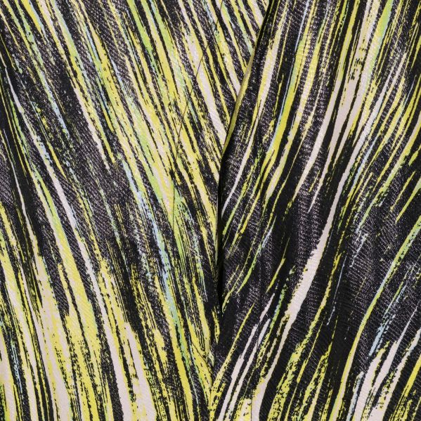 Närbild av tyg med gult och svart abstrakt mönster