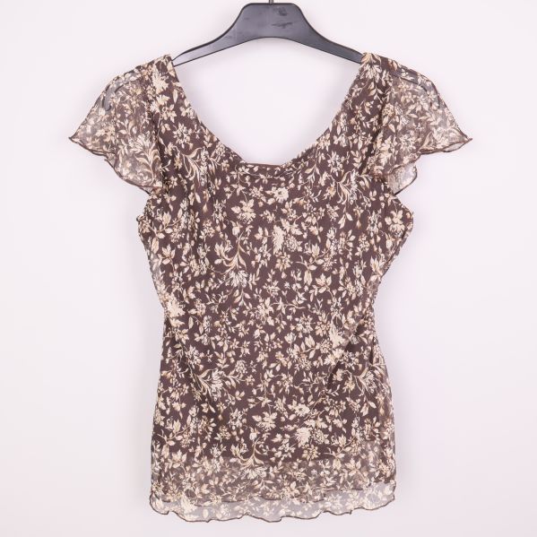 Baksida av brun blommig topp i transparent material