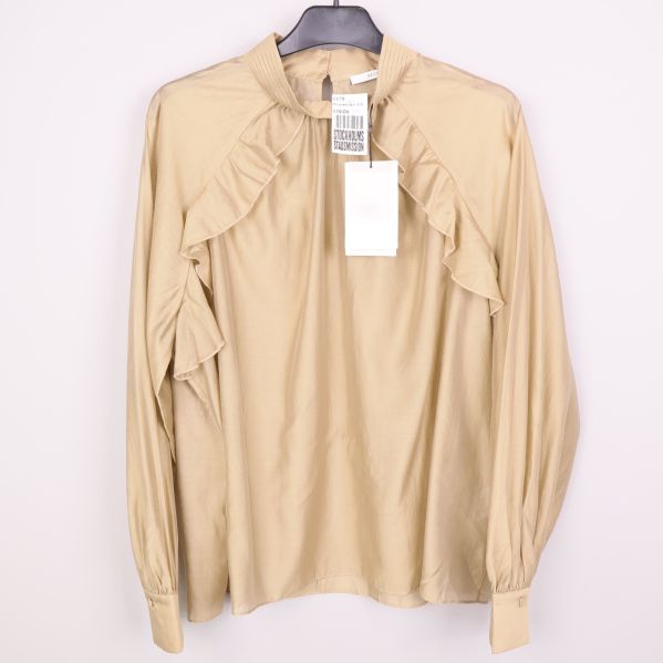 Beige långärmad blus med volangdetaljer framtill