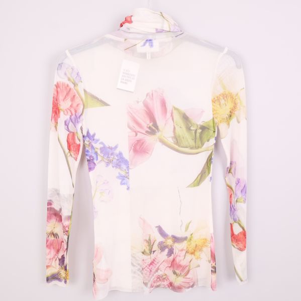 Baksida av blommig meshpolo med lång ärm