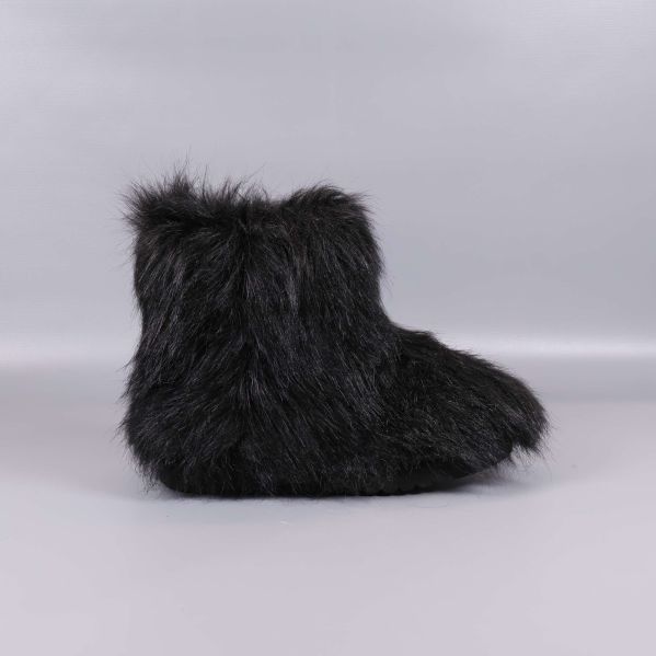 Svarta boots med lång päls fotograferade från sidan