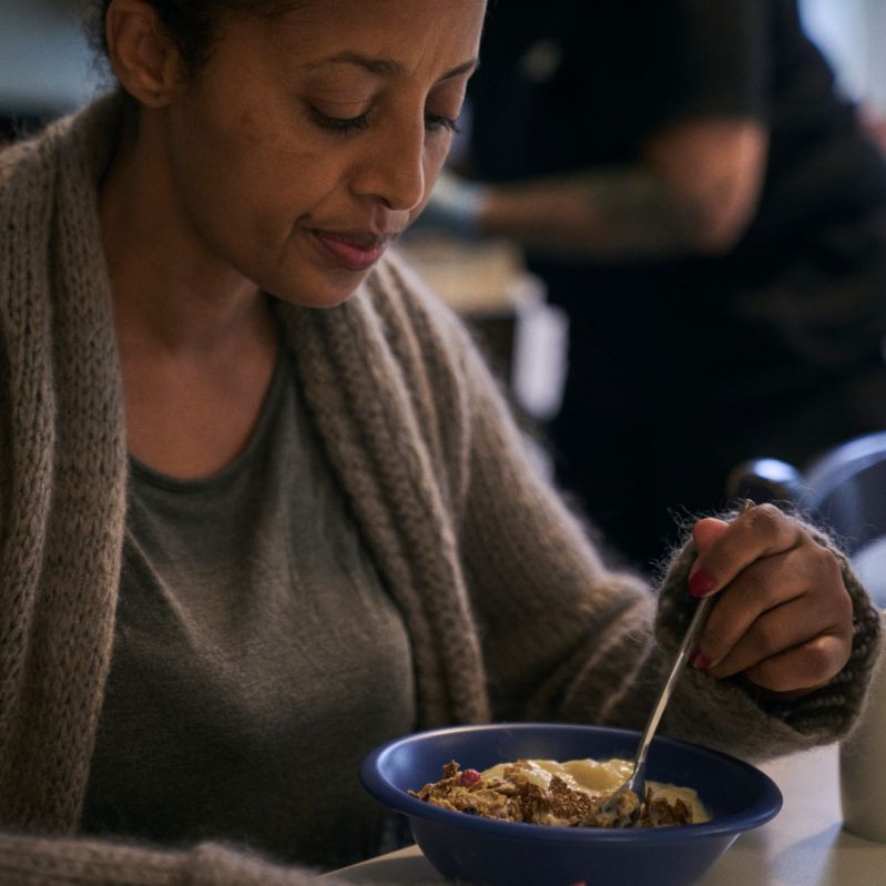 Genrebild kvinna äter mat.