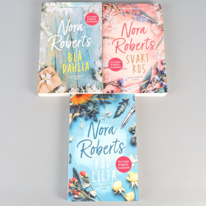 Tre böcker av Nora Roberts med färgglada omslag