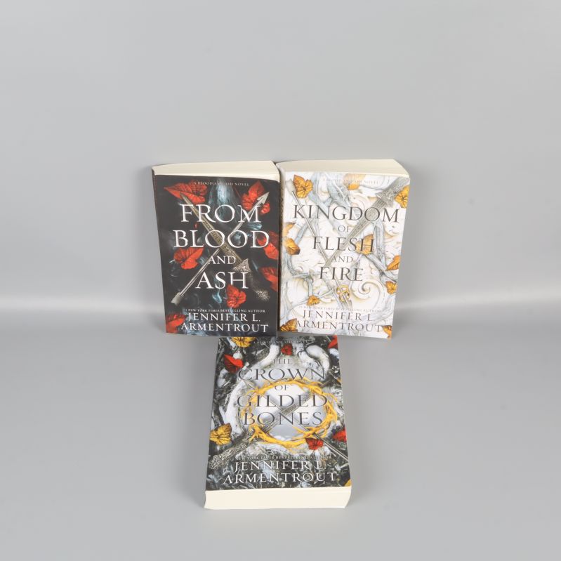 Tre böcker ur From Blood and Ash-serien med färgstarka omslag mot ljus bakgrund