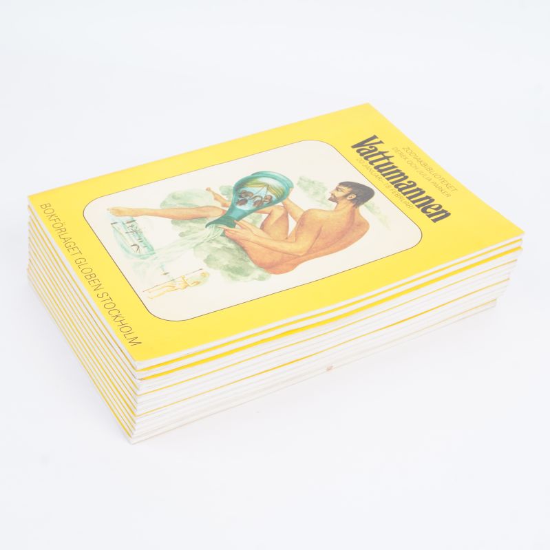 Stapel av gula astrologiböcker med Vattumannen överst