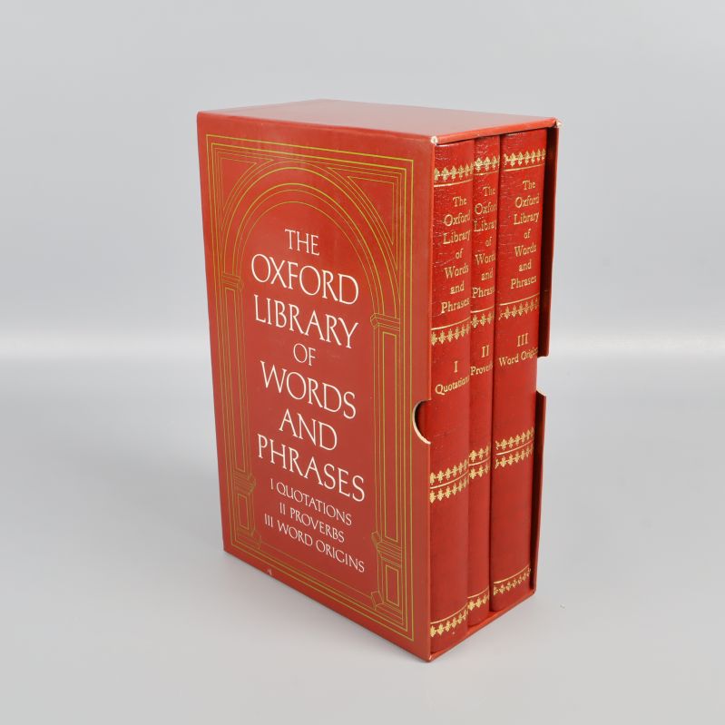 Tre röda böcker i box med guldtext på framsidan