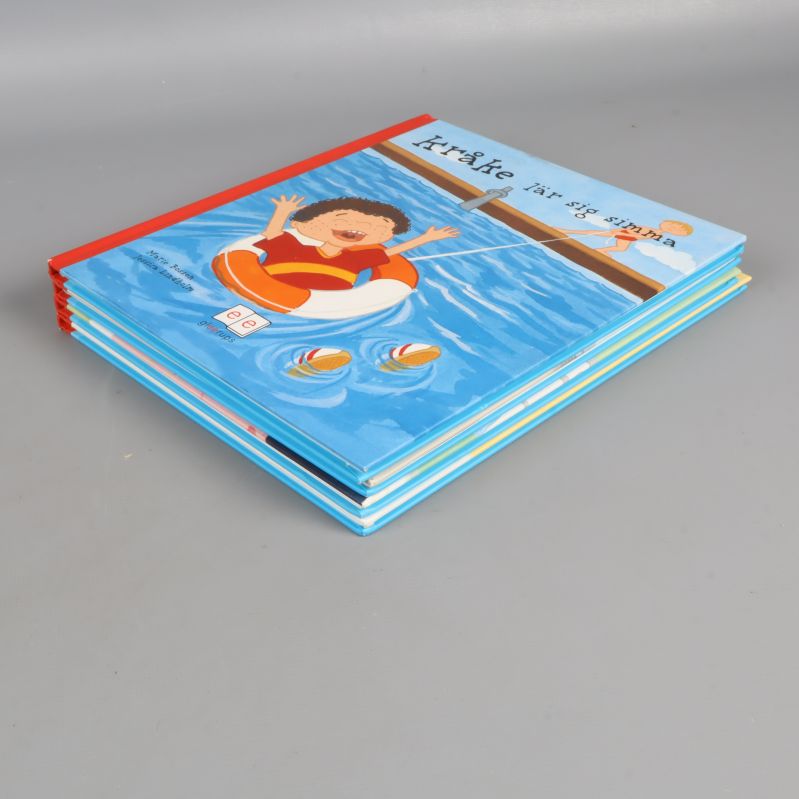 Fyra Kråke-böcker liggande i hög från olika vinklar